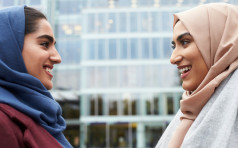 Two British Muslim Women Friends Meeting Outside Office